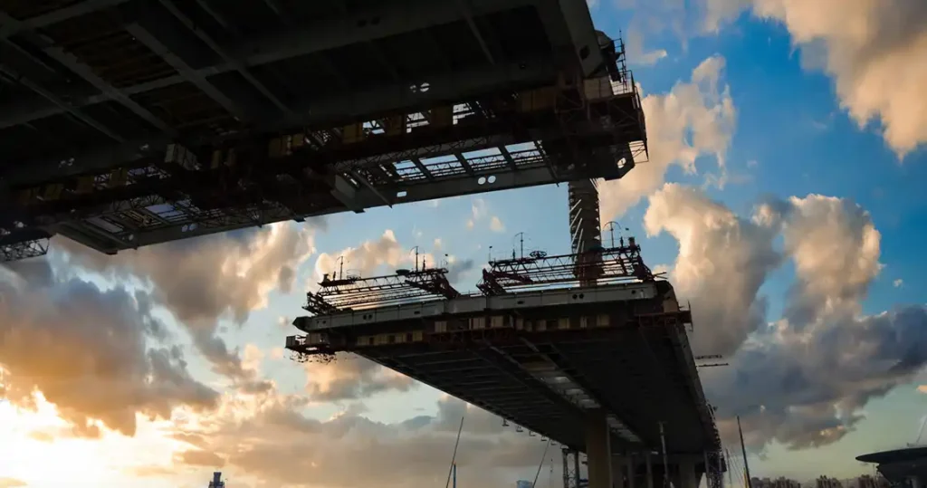 St. Petersburg bridge under construction. The bridge is silhouetted against the sky at sunset