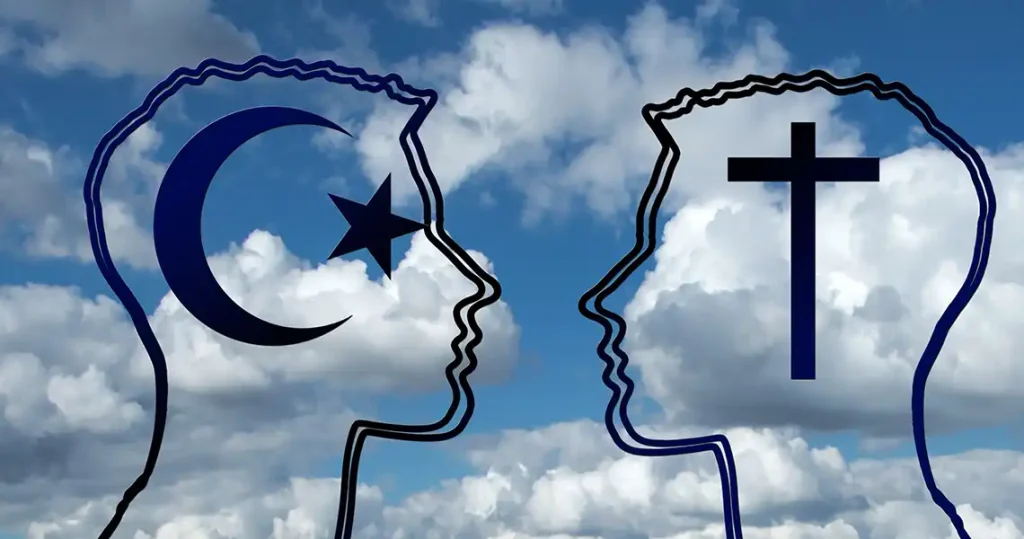 The outline of 2 heads facing each other. Inside one head is the crescent moon and star symbol for Islam and in the other, the cross, as symbol for Christianity. The background is a blue sky with white puffy clouds.