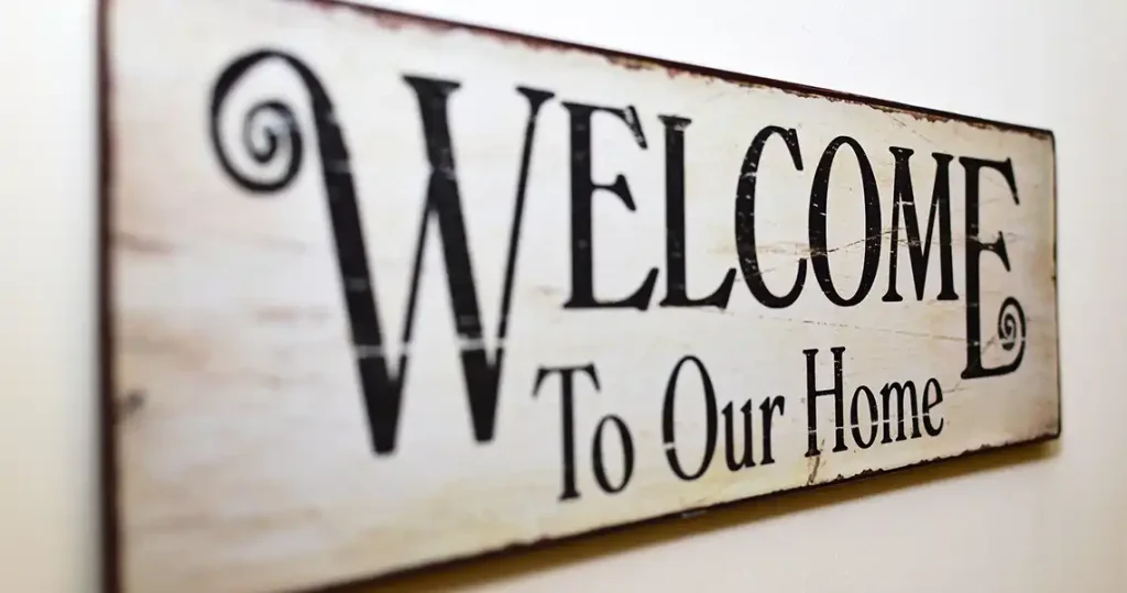 A wood sign saying Welcome to our home